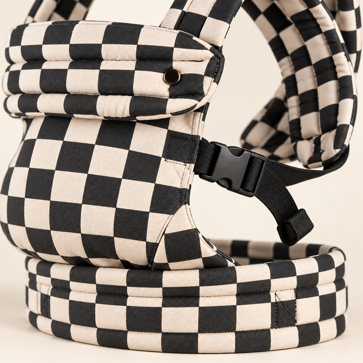 Close-up of buckle, waistband and checkerboard fabric on the Née carrier