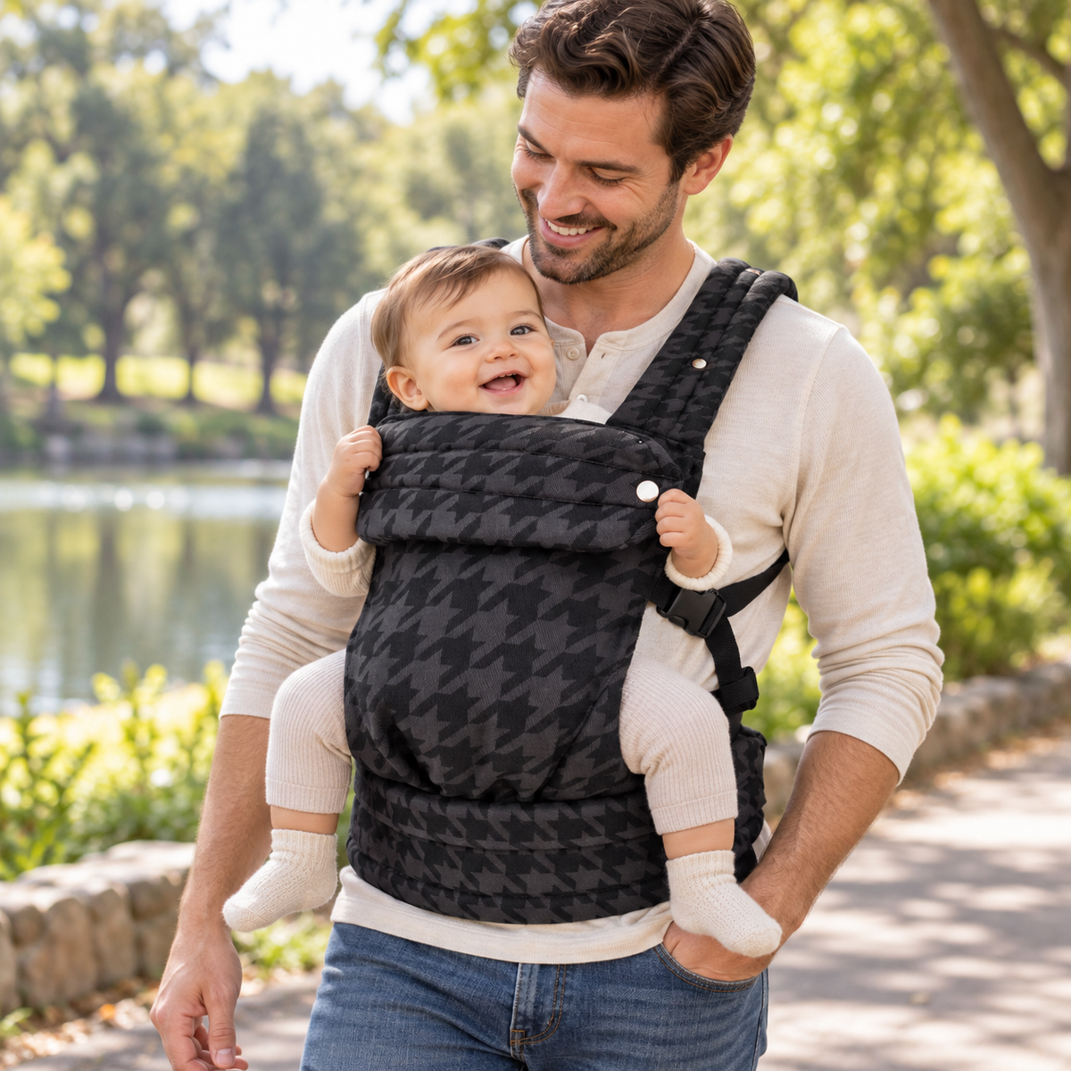 Father wearing the Denim Check ergonomic baby carrier in a front inward carry