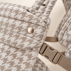 Khaki Houndstooth carrier fabric, snap, buckle, and stitching detail