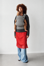 Mother wearing the Née Grand Houndstooth ergonomic baby carrier with baby, full-length view