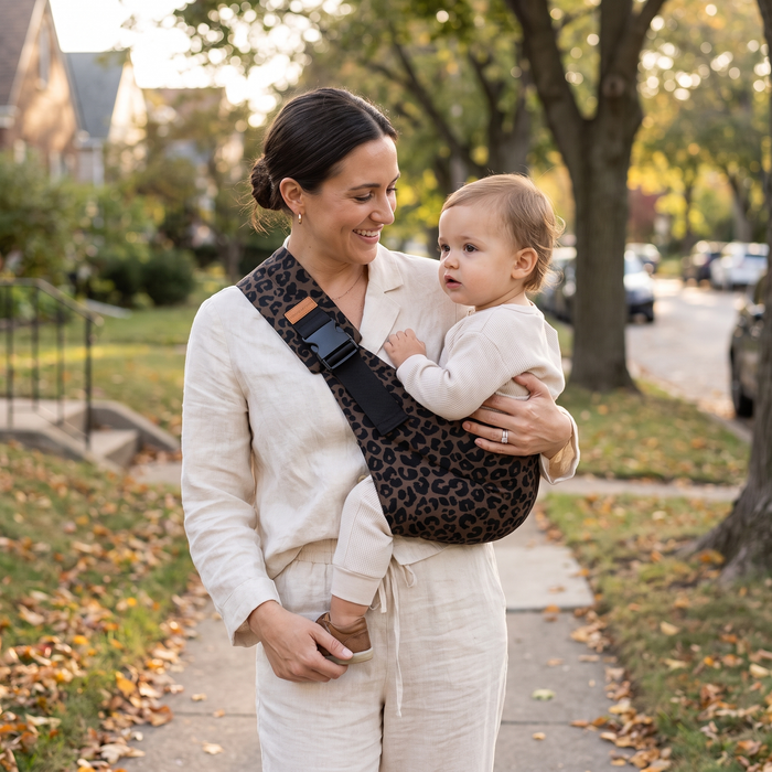 Dark Leopard Print Baby Sling Carrier worn by a parent outdoors