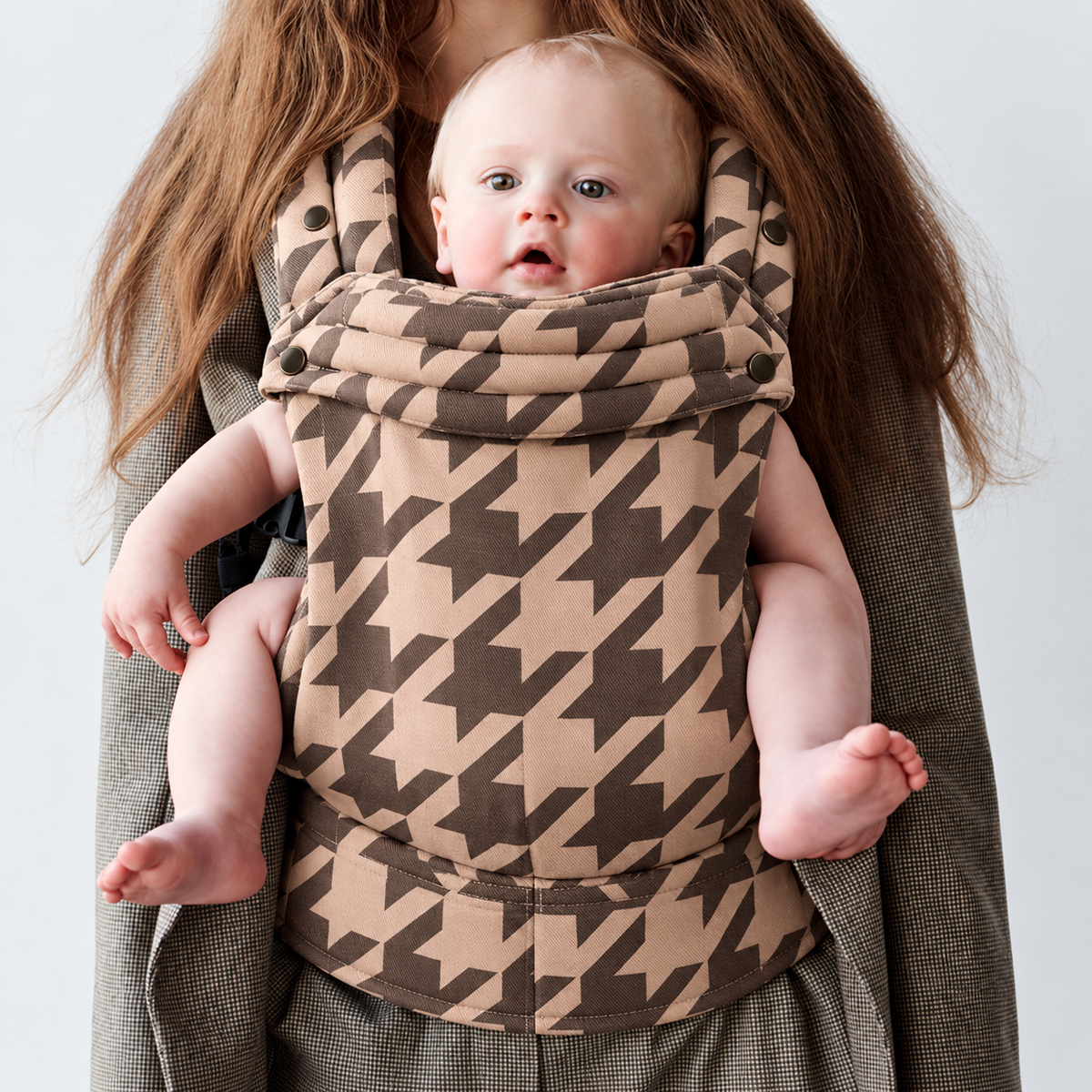 Baby in a front carry in the Née Stone Houndstooth Grey ergonomic baby carrier, close view